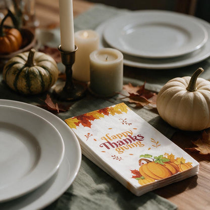 Happy Thanksgiving pumpkin dinner napkins on a Thanksgiving table with candles and pumpkins