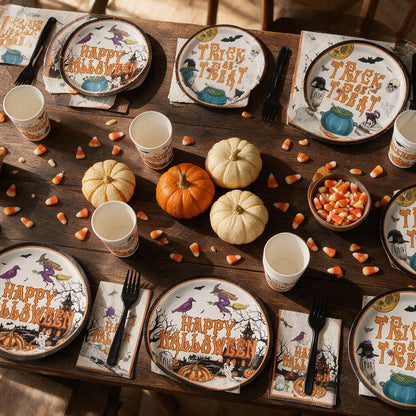 Halloween party table set with vintage Happy Halloween and Trick or Treat plates, cups, napkins and black forks