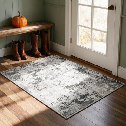 Grey, white and sage abstract washable accent rug in a farmhouse entryway with boots