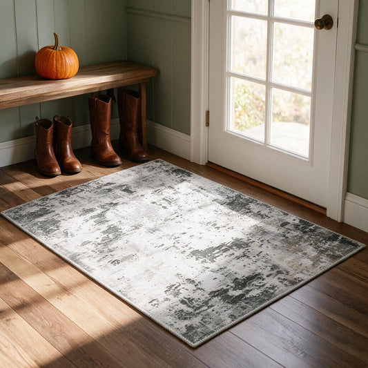 Grey, white and sage abstract washable accent rug in a farmhouse entryway with boots